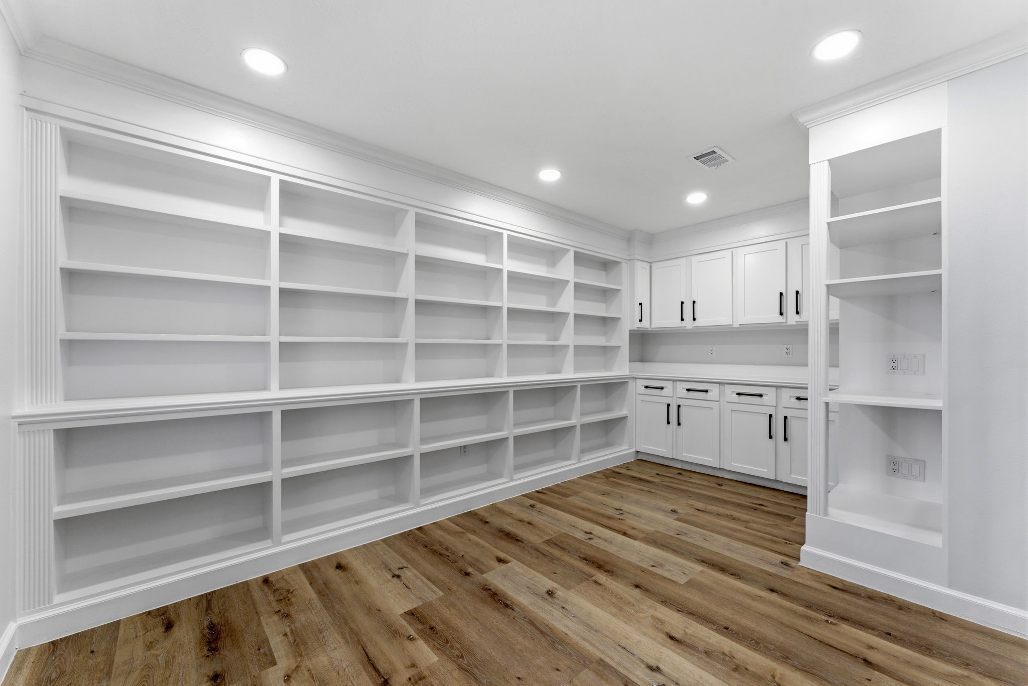 5203 Woodville Lane Spring, TX 77379 - Photo 23 of 50 A bibliophile’s daydream. From floor-to-ceiling built-ins to crisp white cabinetry, this room is an organizer’s greatest hits album. It’s a blank canvas for your personal library or a world-class hobby room.