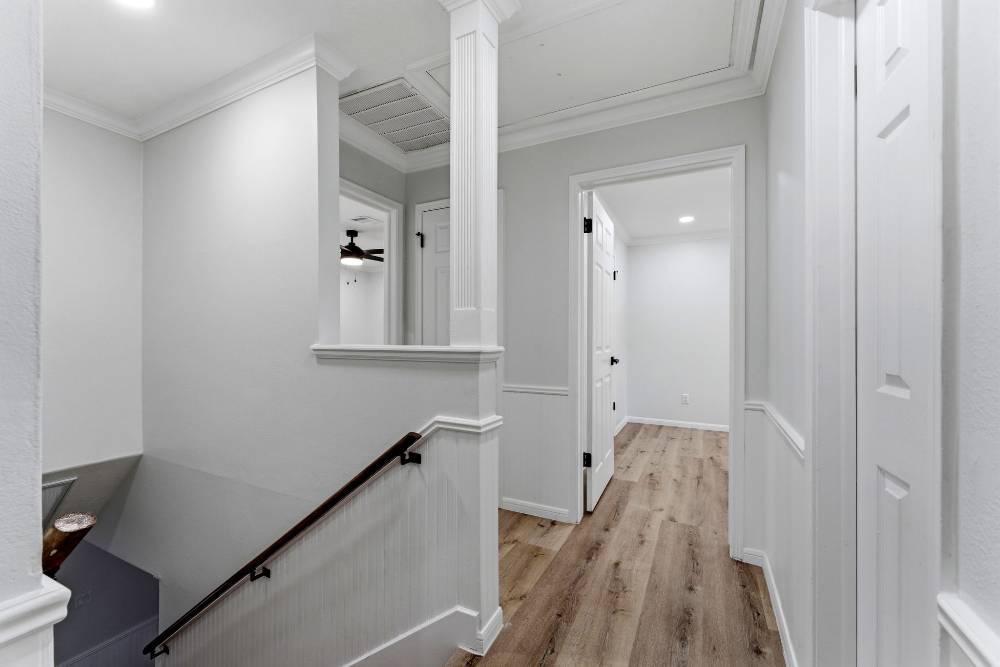 5203 Woodville Lane Spring, TX 77379 - Photo 28 of 50 From the elegant fluted column to the classic beadboard wainscoting, the upper-level landing serves as a grand introduction to the home's private quarters.