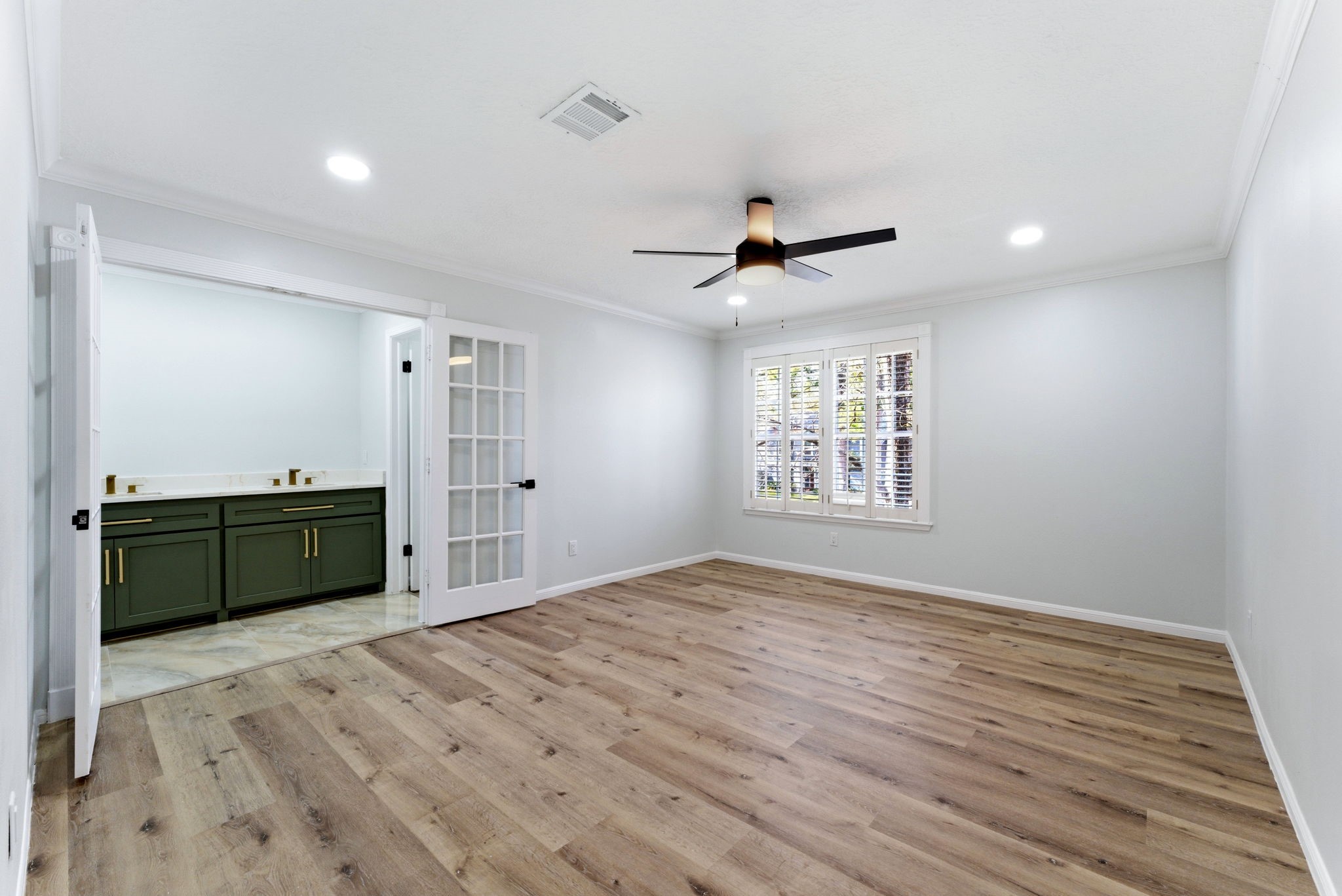 5203 Woodville Lane Spring, TX 77379 - Photo 29 of 50 The ultimate Primary Suite. French doors swing open to reveal a stunning ensuite bath, creating an open, luxurious atmosphere you’ll love waking up to.