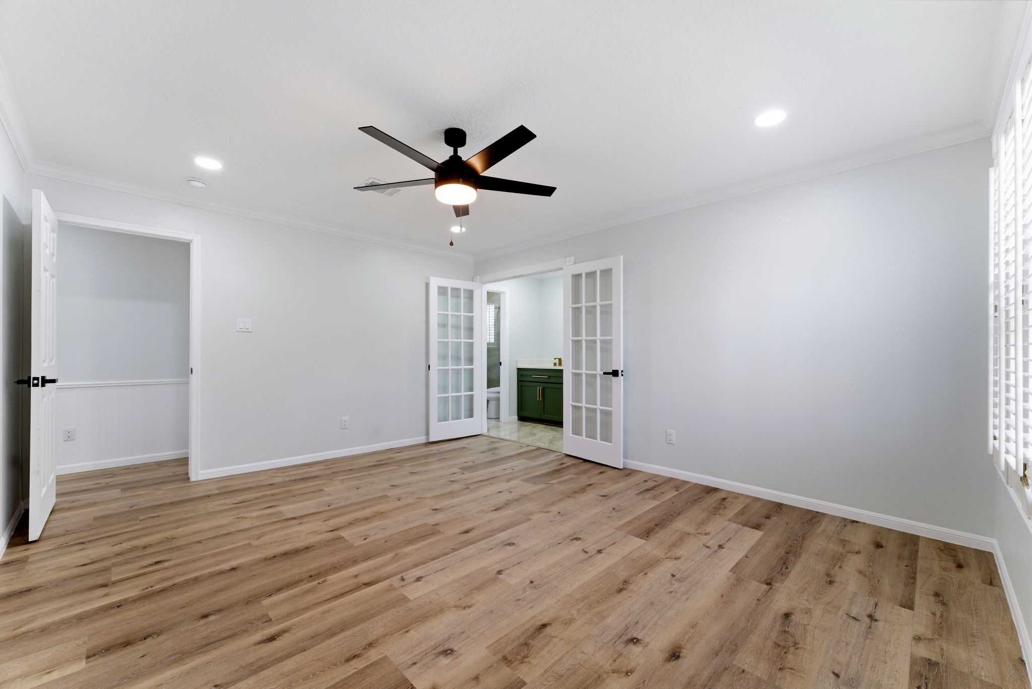5203 Woodville Lane Spring, TX 77379 - Photo 30 of 50 Space, light, and luxury. This expansive primary bedroom offers the perfect balance of natural light and high-end design, featuring a direct view into your private spa-like bathroom.