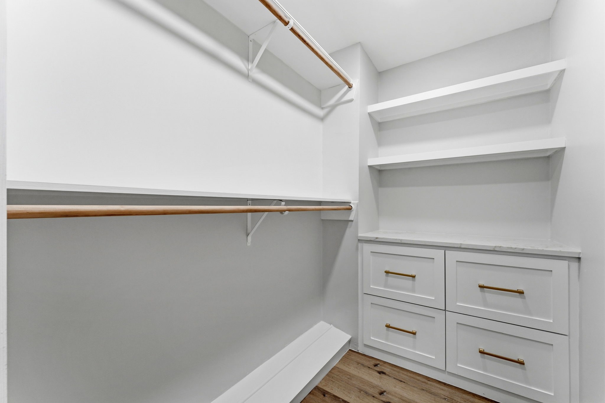 5203 Woodville Lane Spring, TX 77379 - Photo 33 of 50 Organization evolved. This custom walk-in closet features built-in dresser drawers, marble-topped surfaces, and ample hanging space to keep your wardrobe effortlessly organized.