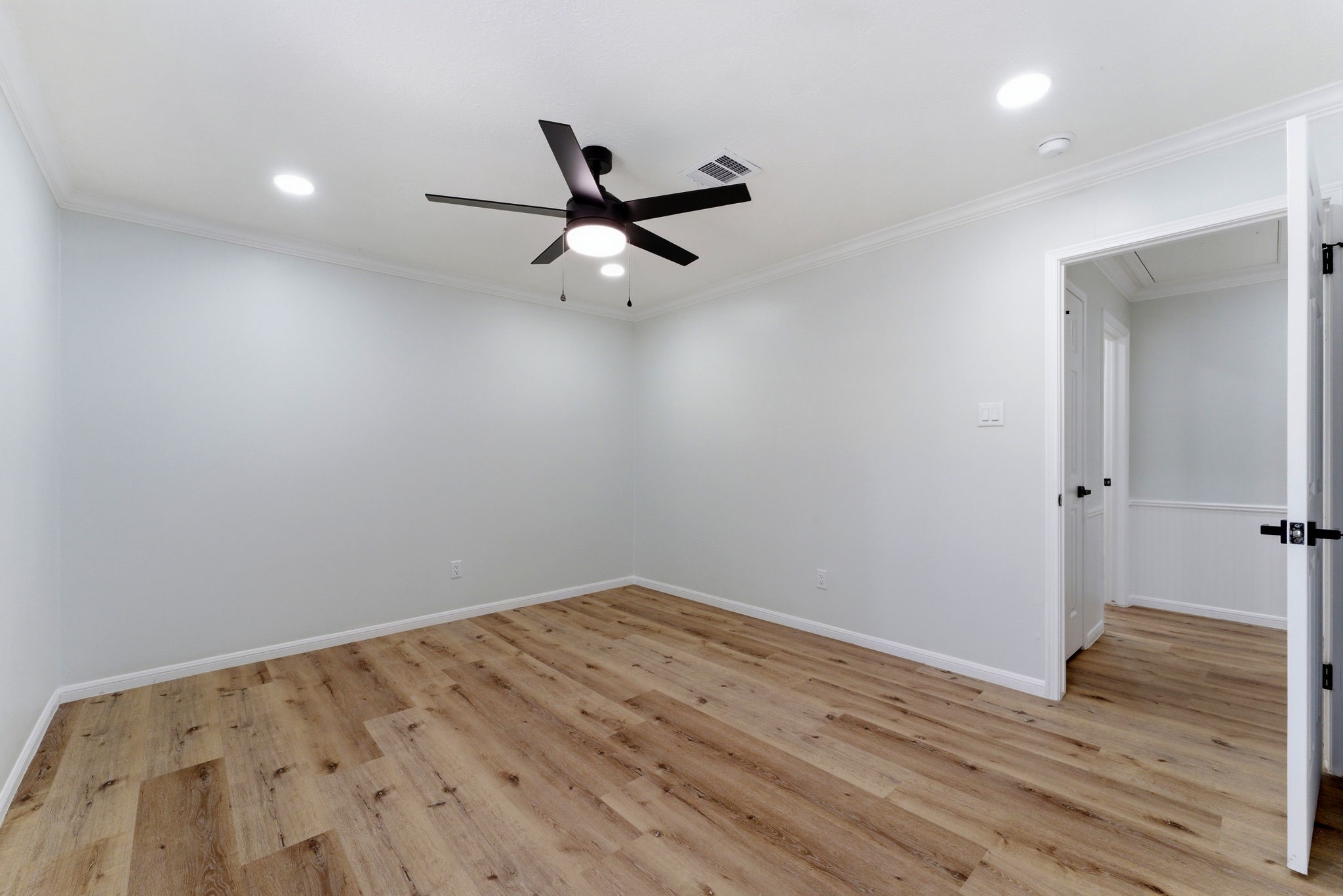 5203 Woodville Lane Spring, TX 77379 - Photo 35 of 50 Crisp white walls and sleek black accents, including a contemporary ceiling fan and designer hardware, offer a perfectly balanced, move-in-ready aesthetic.