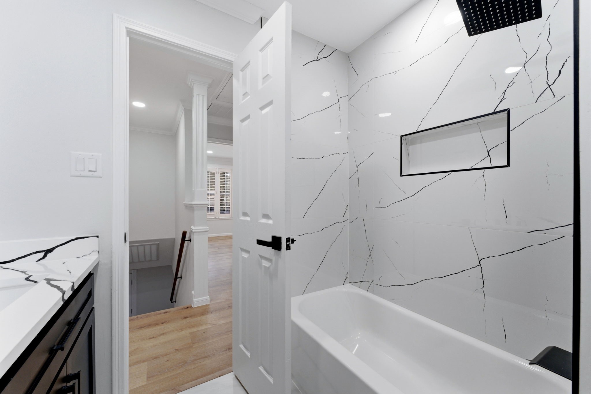 5203 Woodville Lane Spring, TX 77379 - Photo 38 of 50 Custom marble-patterned tiling and a built-in shower niche elevate the everyday, turning your morning routine into a luxurious escape.