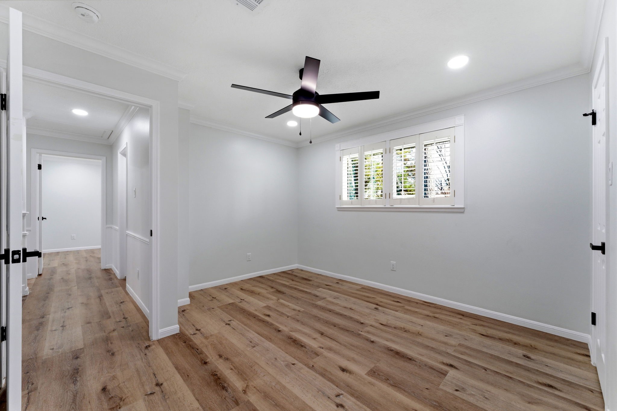 5203 Woodville Lane Spring, TX 77379 - Photo 42 of 50 A breath of fresh air. This bright, airy bedroom features contemporary wide-plank flooring and a sleek designer fan, offering a clean slate for your personal style.