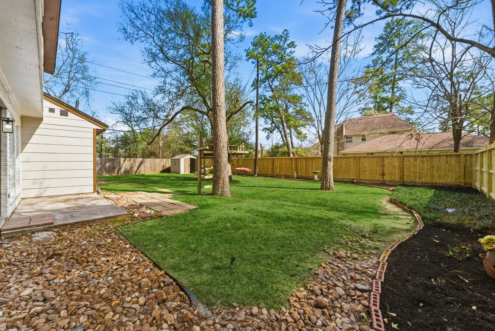 5203 Woodville Lane Spring, TX 77379 - Photo 46 of 50 Step into a sprawling, fully-fenced backyard—a blank canvas for gardening, play, or weekend relaxation.