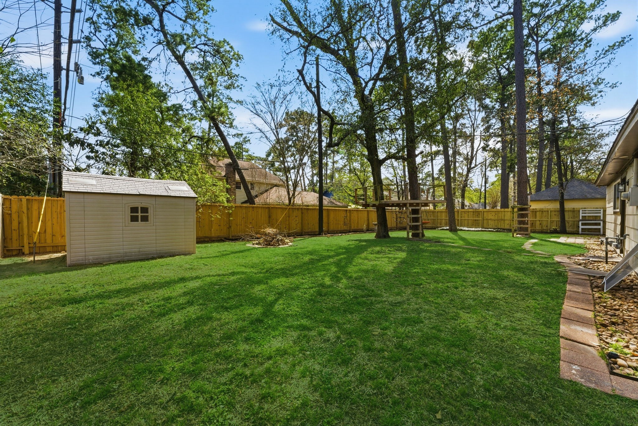 5203 Woodville Lane Spring, TX 77379 - Photo 50 of 50 The included storage shed ensures your lawn tools stay organized, keeping your vast green lawn looking its best.
