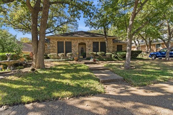 4109 Hackmore Loop Irving, TX 75061 - Photo 1 of 13 a front view of a house with garden and trees