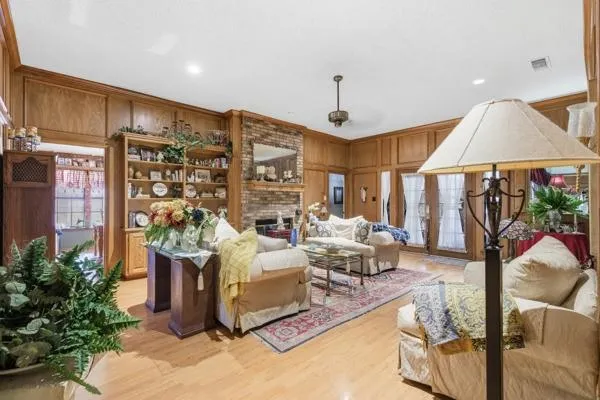 a living room with fireplace furniture and a chandelier