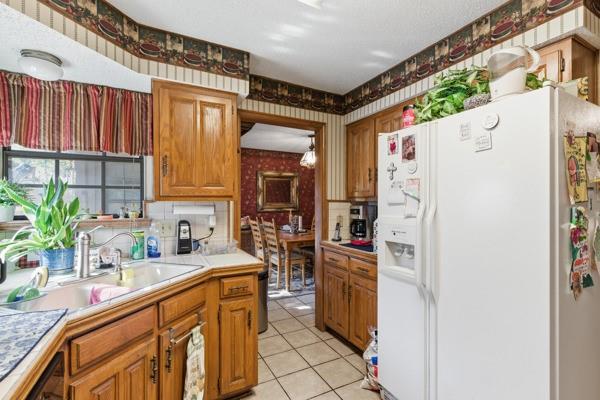 4109 Hackmore Loop Irving, TX 75061 - Photo 9 of 13 a kitchen with a refrigerator and a sink