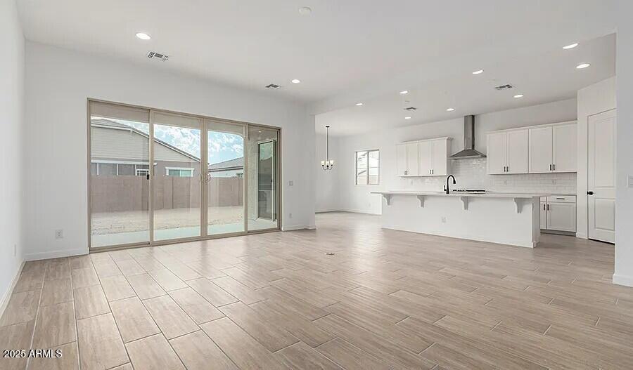 21837 East Bonanza Court Queen Creek, AZ 85142 - Photo 13 of 15 a view of kitchen with wooden floor and window