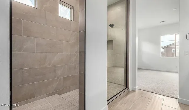 a bathroom with a double vanity sink and a mirror