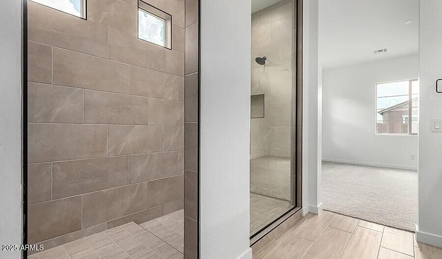 21837 East Bonanza Court Queen Creek, AZ 85142 - Photo 14 of 15 a bathroom with a glass shower door and a window