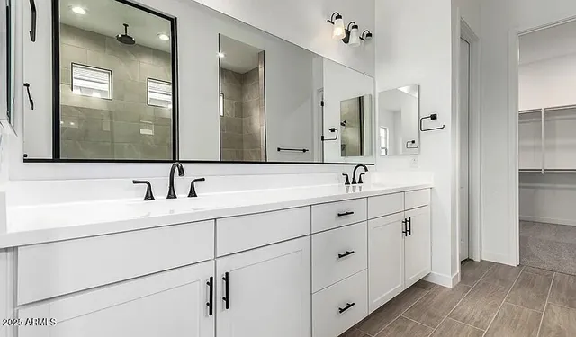 a bathroom with double sink and a mirror