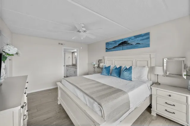 a bedroom with a bed a flat screen tv and a couch