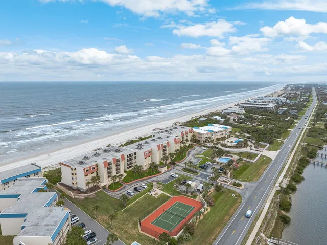 an aerial view of a house with a ocean view
