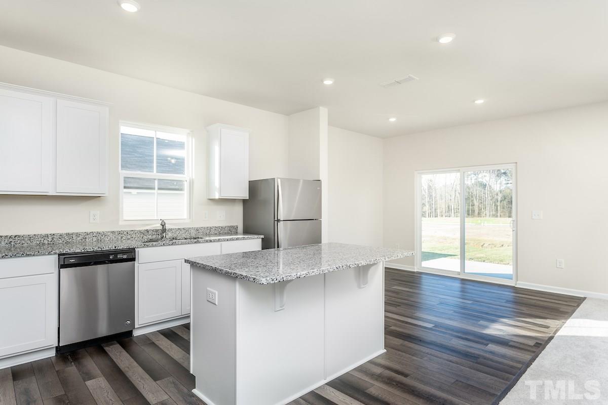 3525 Sugarplum Road Raleigh, NC 27604 - Photo 3 of 11 a kitchen with stainless steel appliances granite countertop a stove a sink and a microwave