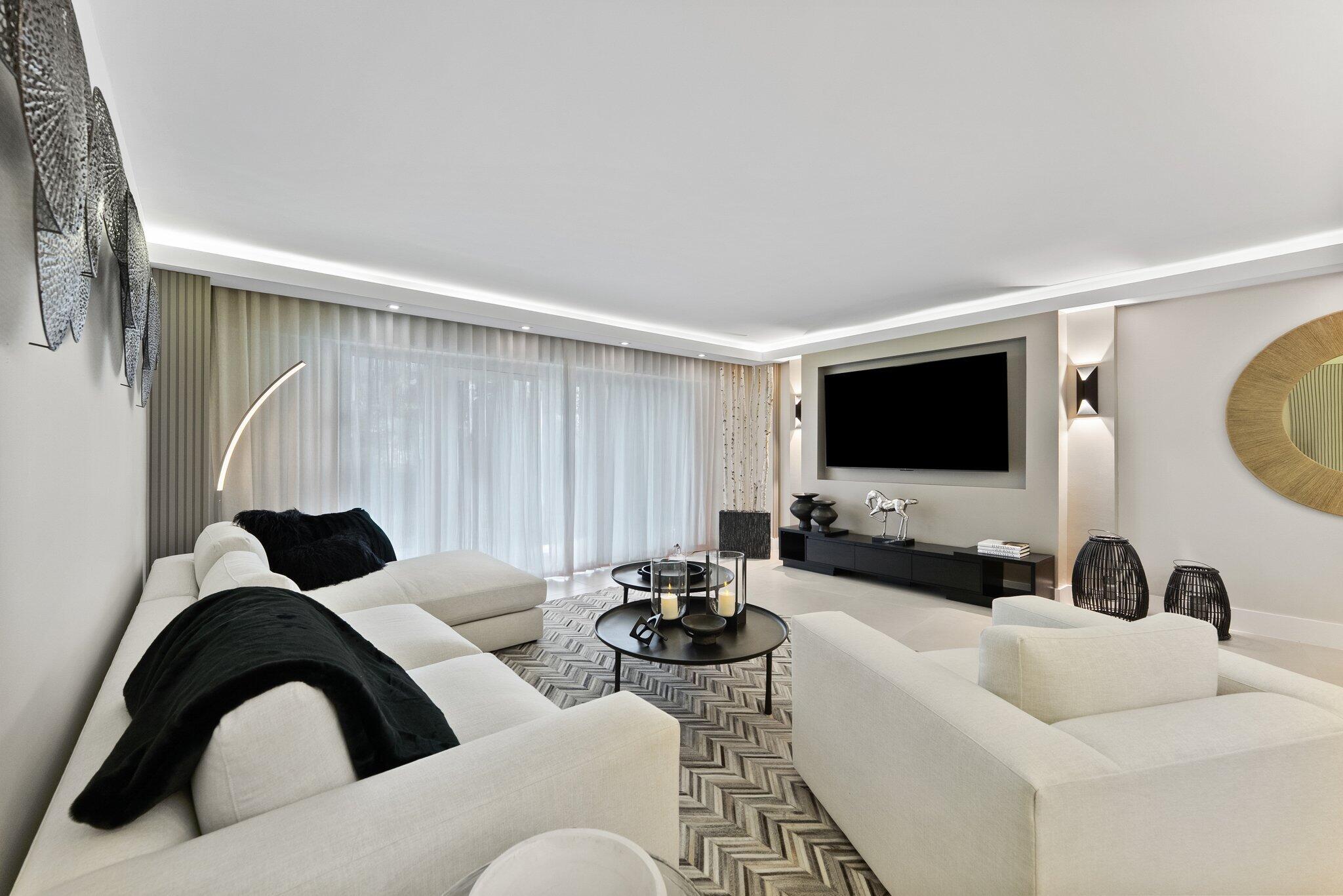 875 East Camino Real, Unit 2G Boca Raton, FL 33432 - Photo 13 of 55 a living room with furniture and a flat screen tv