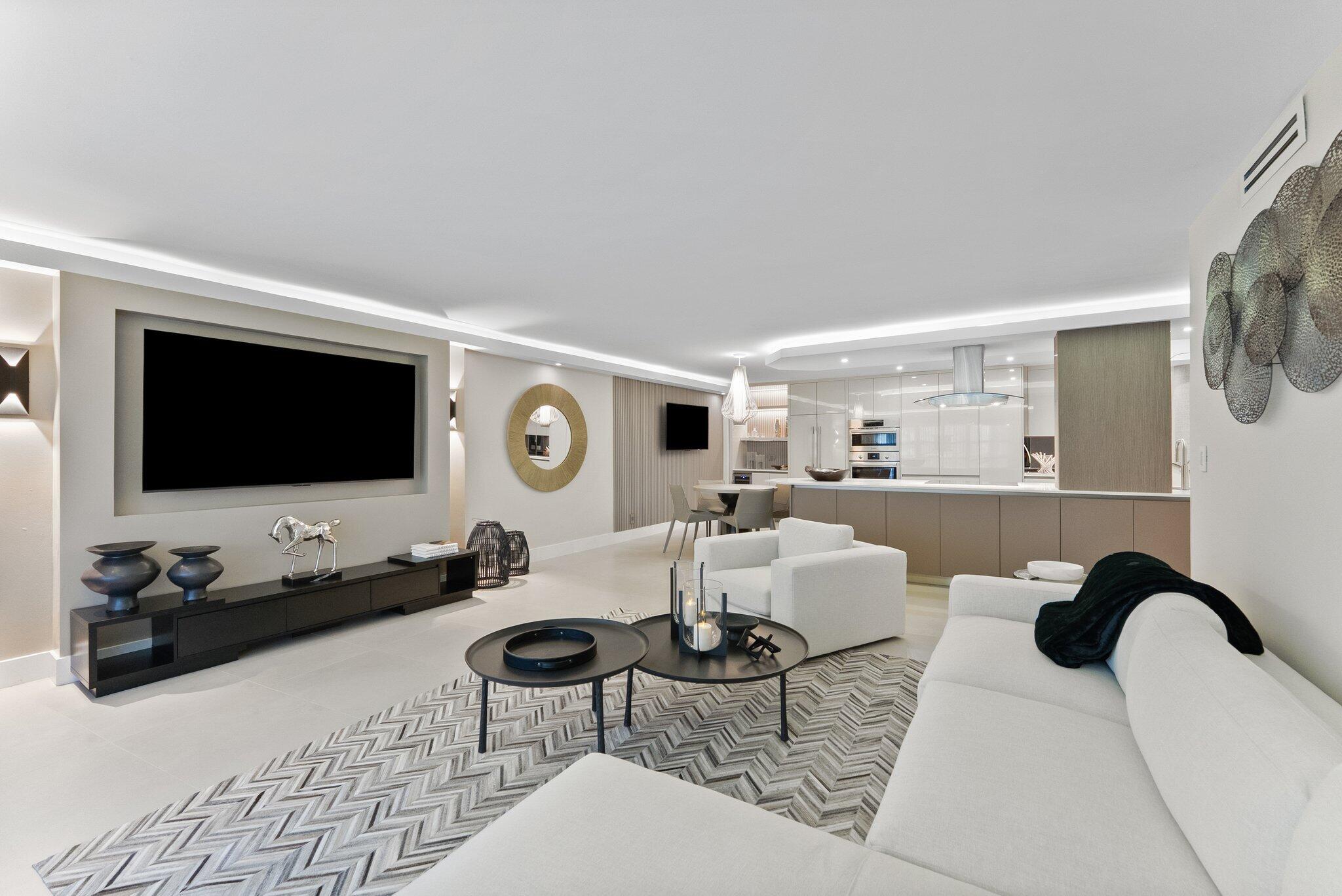 875 East Camino Real, Unit 2G Boca Raton, FL 33432 - Photo 14 of 55 a living room with furniture and a flat screen tv