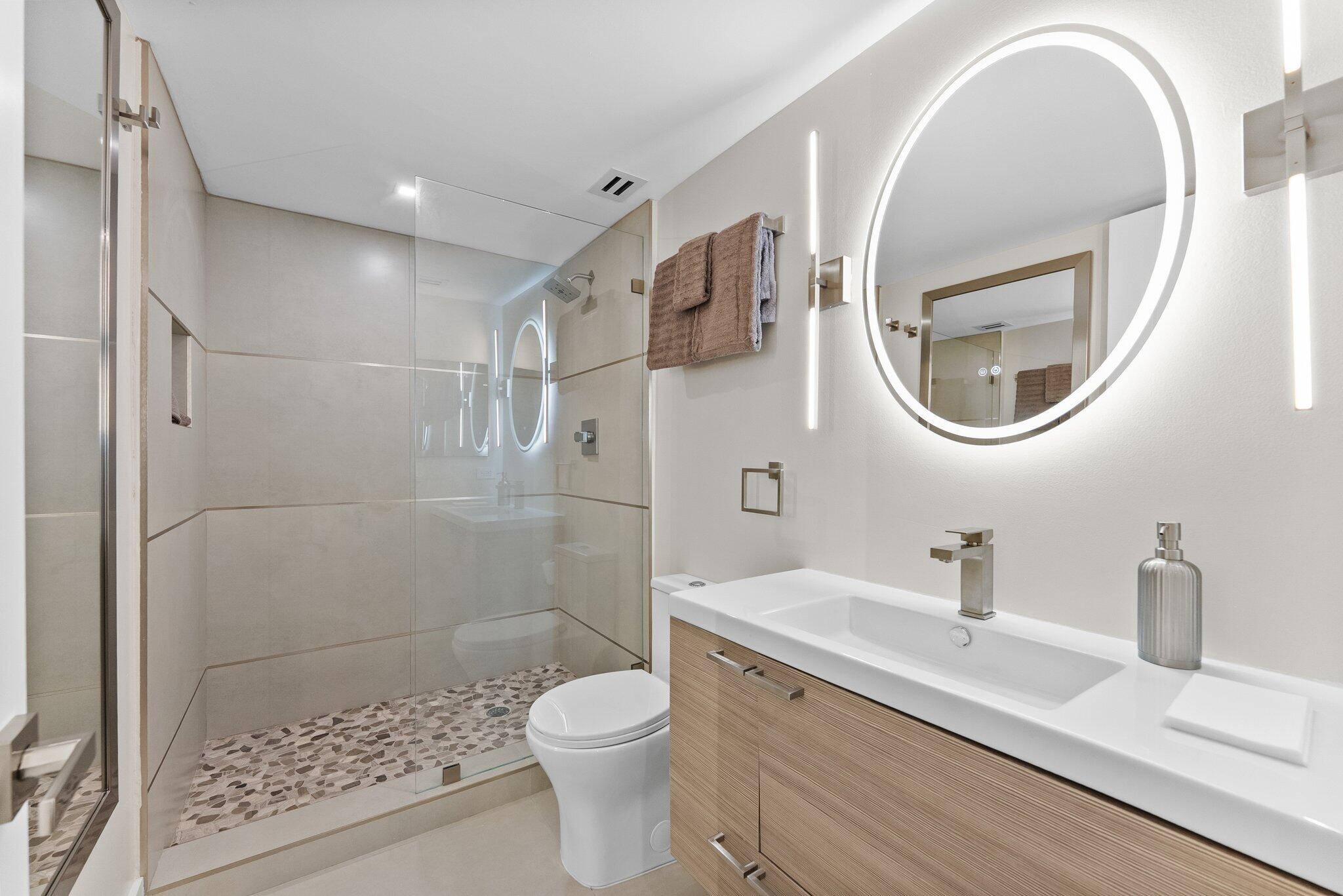 875 East Camino Real, Unit 2G Boca Raton, FL 33432 - Photo 16 of 55 a bathroom with a sink a toilet and shower