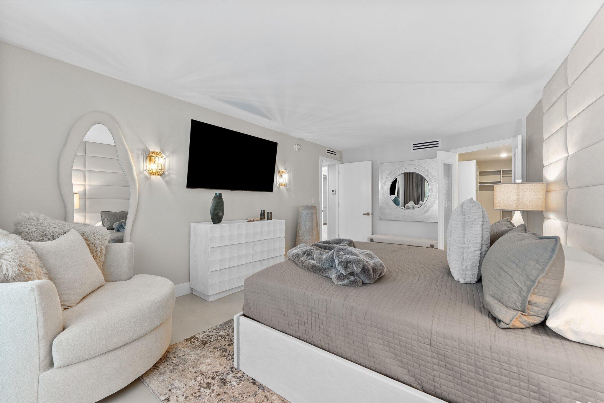 875 East Camino Real, Unit 2G Boca Raton, FL 33432 - Photo 19 of 55 a living room with furniture and a flat screen tv