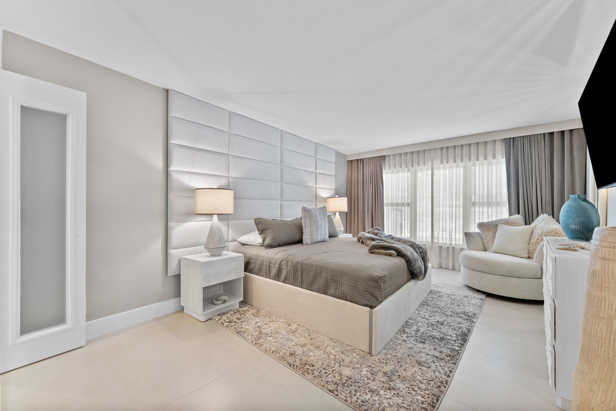 875 East Camino Real, Unit 2G Boca Raton, FL 33432 - Photo 21 of 55 a living room with furniture and a large window