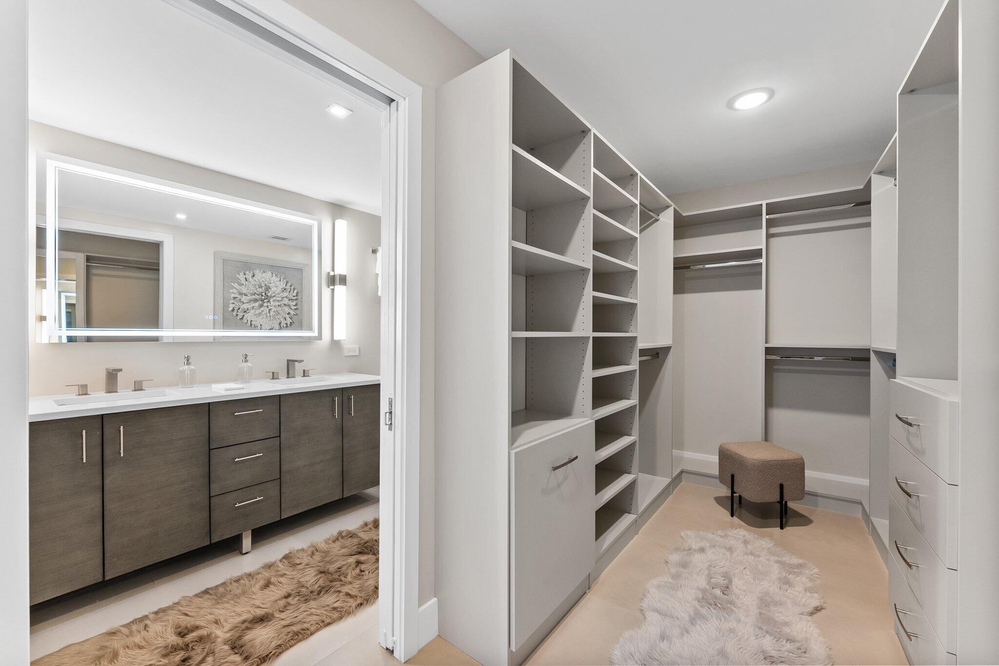 875 East Camino Real, Unit 2G Boca Raton, FL 33432 - Photo 23 of 55 a bathroom with a sink a toilet and a mirror