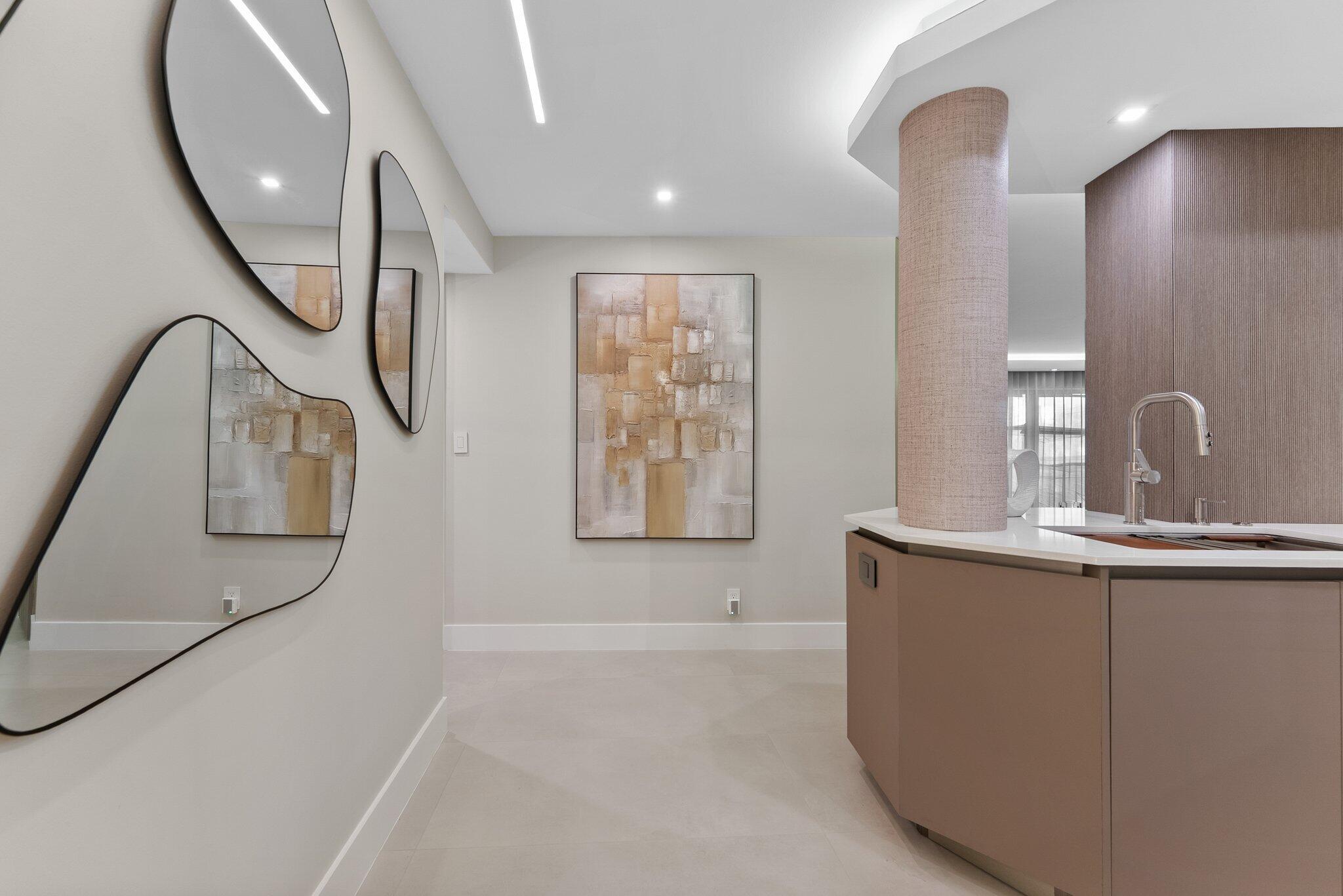 875 East Camino Real, Unit 2G Boca Raton, FL 33432 - Photo 3 of 55 a bathroom with a sink a mirror and a bathtub