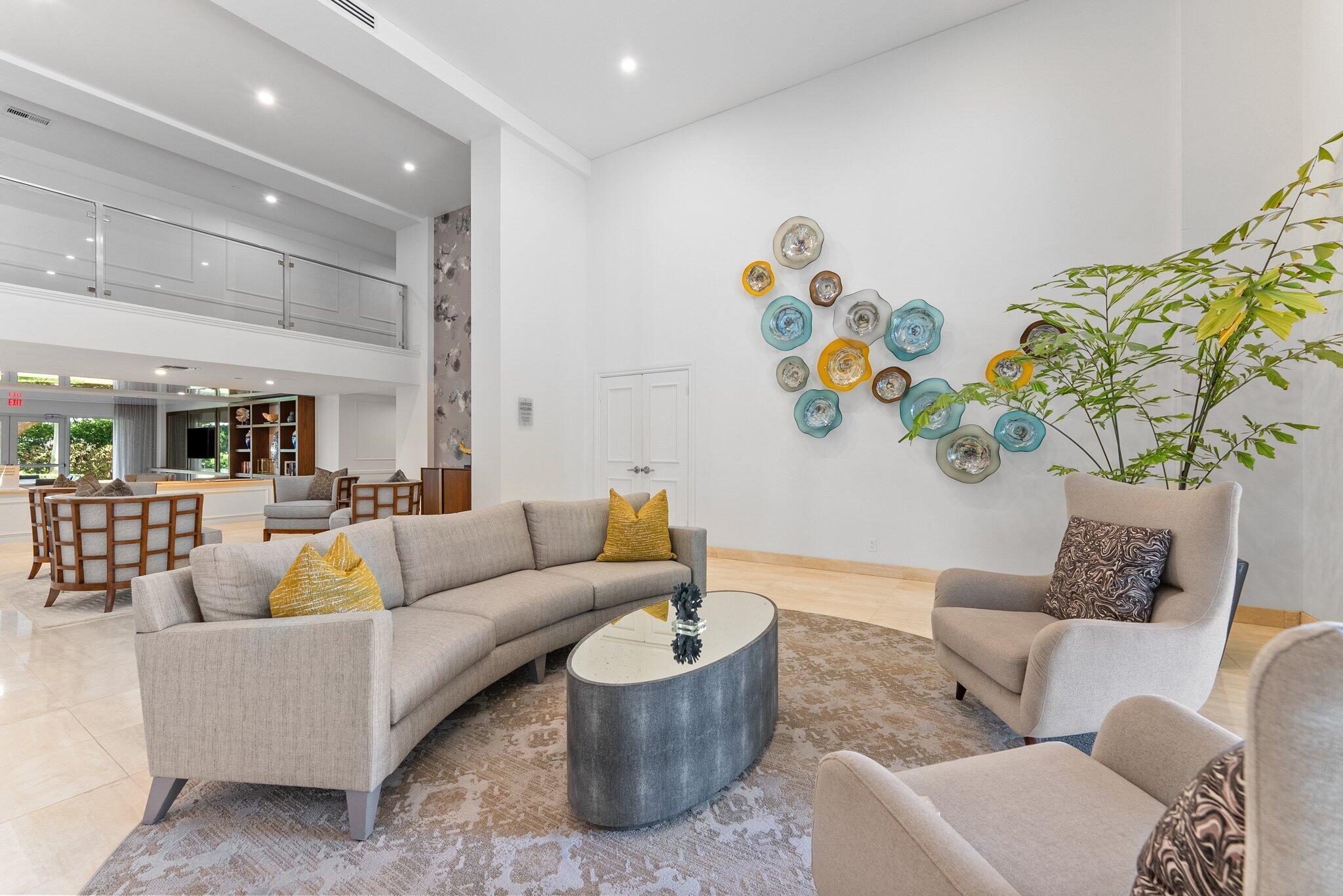 875 East Camino Real, Unit 2G Boca Raton, FL 33432 - Photo 47 of 55 a living room with furniture and flowers