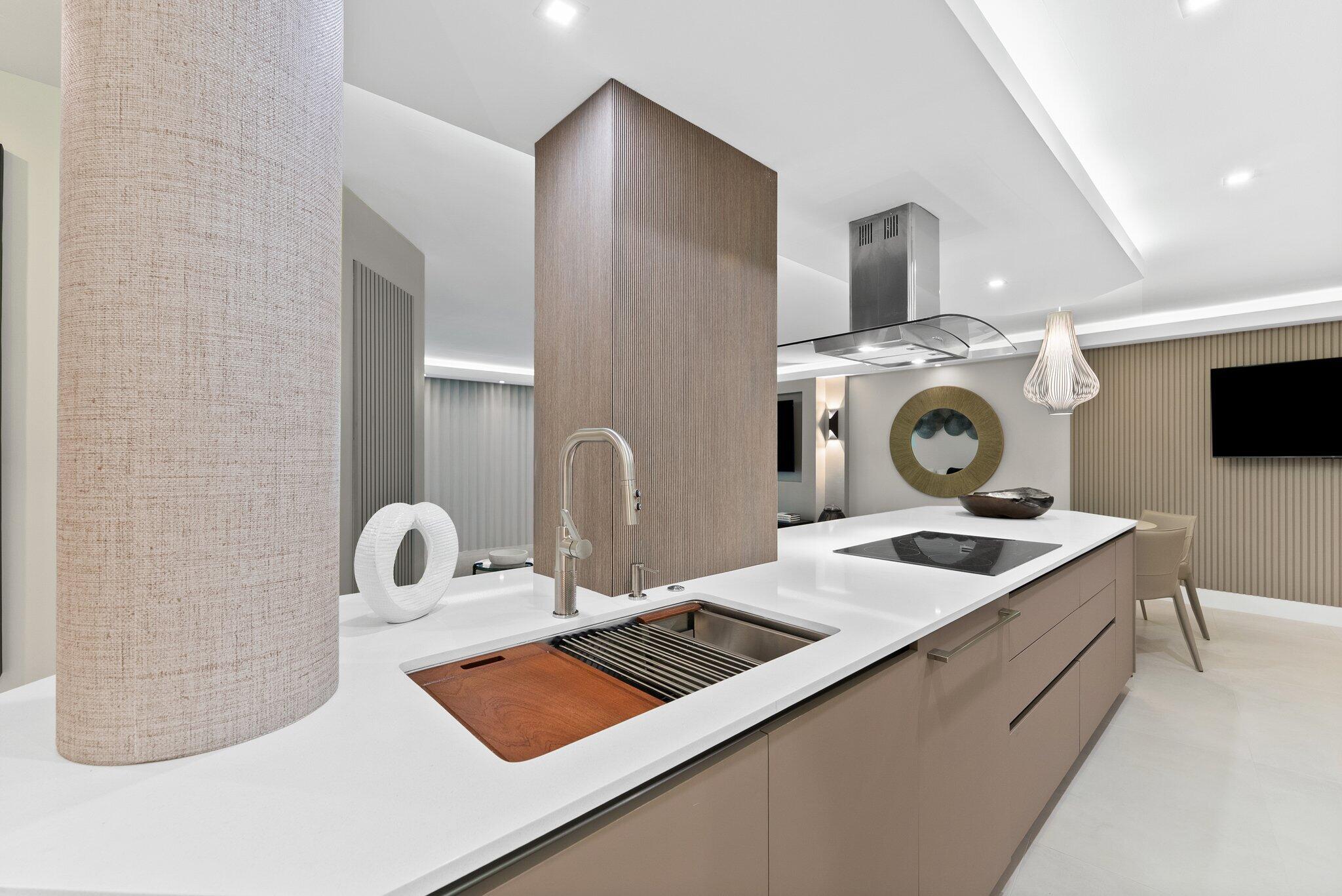 875 East Camino Real, Unit 2G Boca Raton, FL 33432 - Photo 5 of 55 a kitchen with a stove and a white cabinets