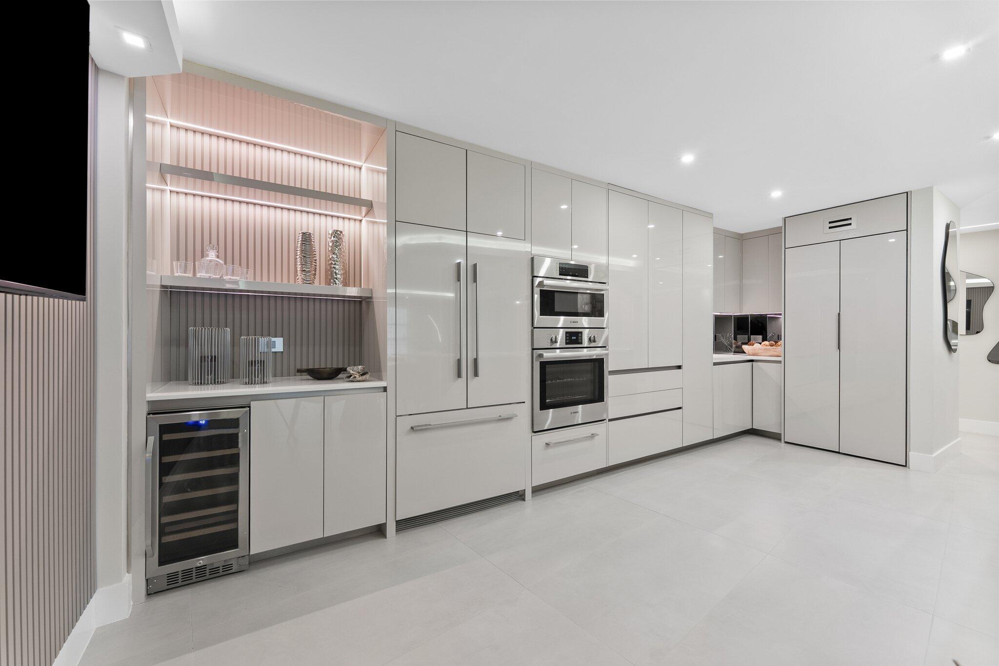 875 East Camino Real, Unit 2G Boca Raton, FL 33432 - Photo 10 of 55 a kitchen with granite countertop white cabinets and refrigerator