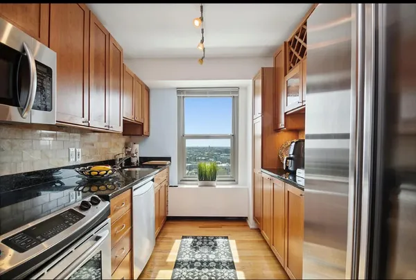 a kitchen with a refrigerator a stove a sink and a window
