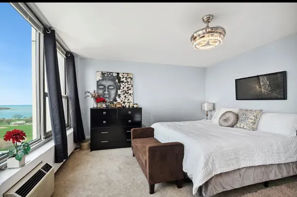 a bedroom with a bed and a chandelier