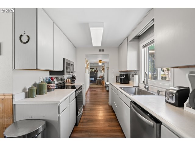 33968 East Loop Road Stanfield, OR 97875 - Photo 11 of 48 a kitchen with a sink dishwasher stove and white cabinets