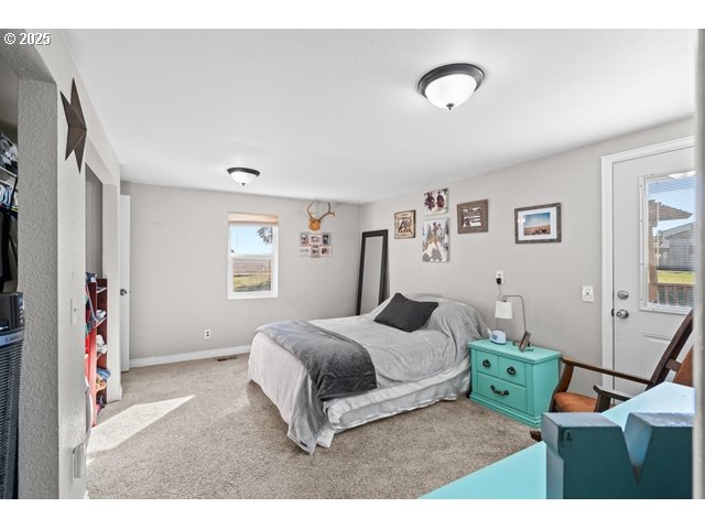 33968 East Loop Road Stanfield, OR 97875 - Photo 13 of 48 a bedroom with a bed and wooden floor