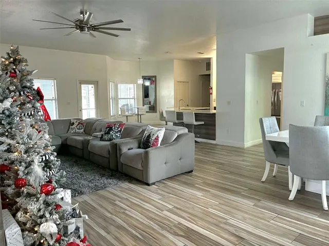 a view of a kitchen with kitchen island a dining table and chairs