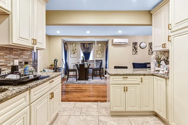 a kitchen with stainless steel appliances kitchen island granite countertop a sink and cabinets