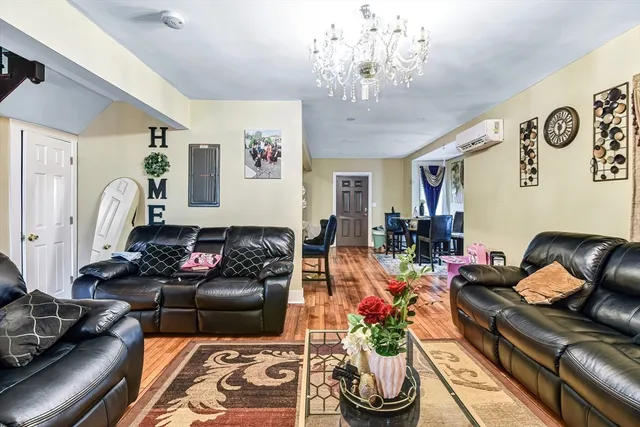 a living room with furniture and a chandelier