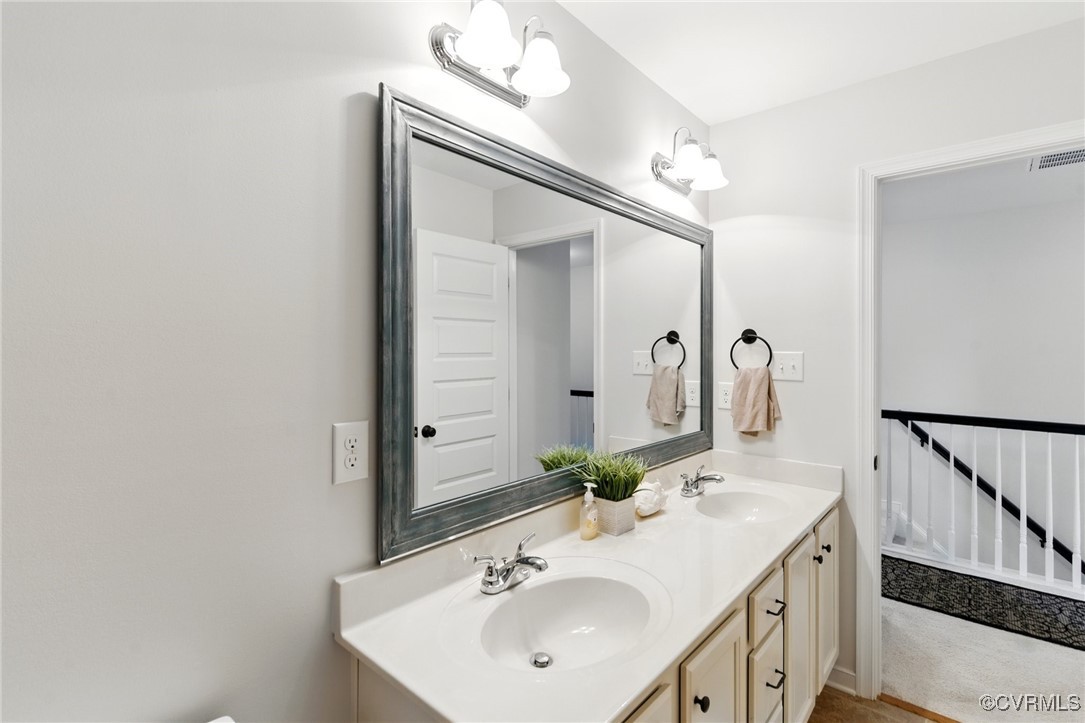 2201 Vandover Road Henrico, VA 23229 - Photo 25 of 43 a bathroom with a sink a mirror and a vanity