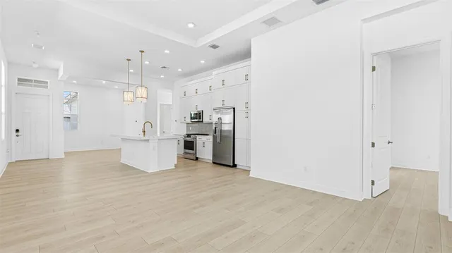 a view of a kitchen with a refrigerator and a sink