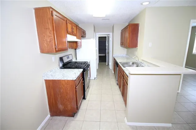 an empty room with mirror and a sink