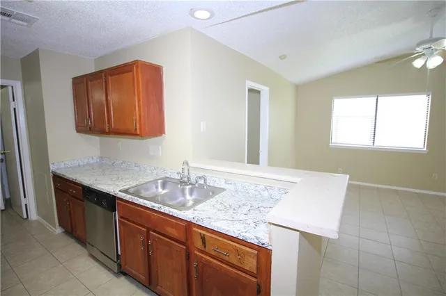 a kitchen with stainless steel appliances granite countertop a stove and a refrigerator