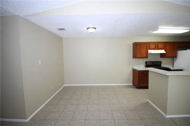 an empty room with a ceiling fan and a mirror