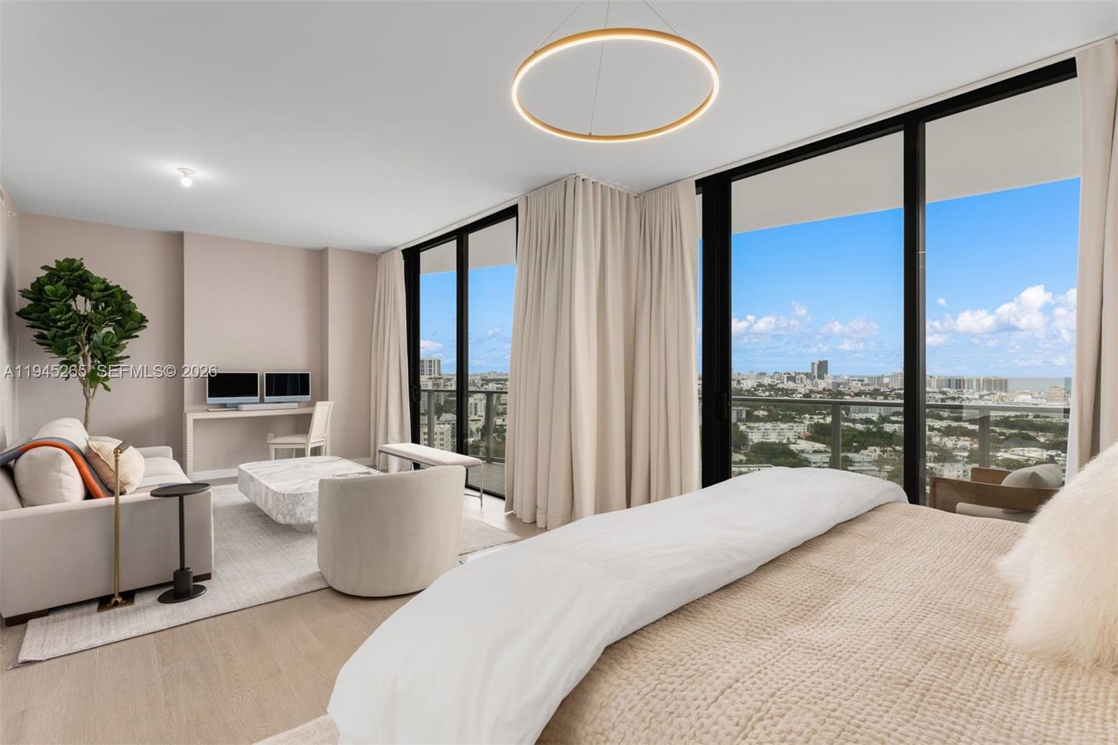 500 Alton Road, Unit 2105 Miami Beach, FL 33139 - Photo 13 of 44 a spacious bedroom with a large bed and a large window