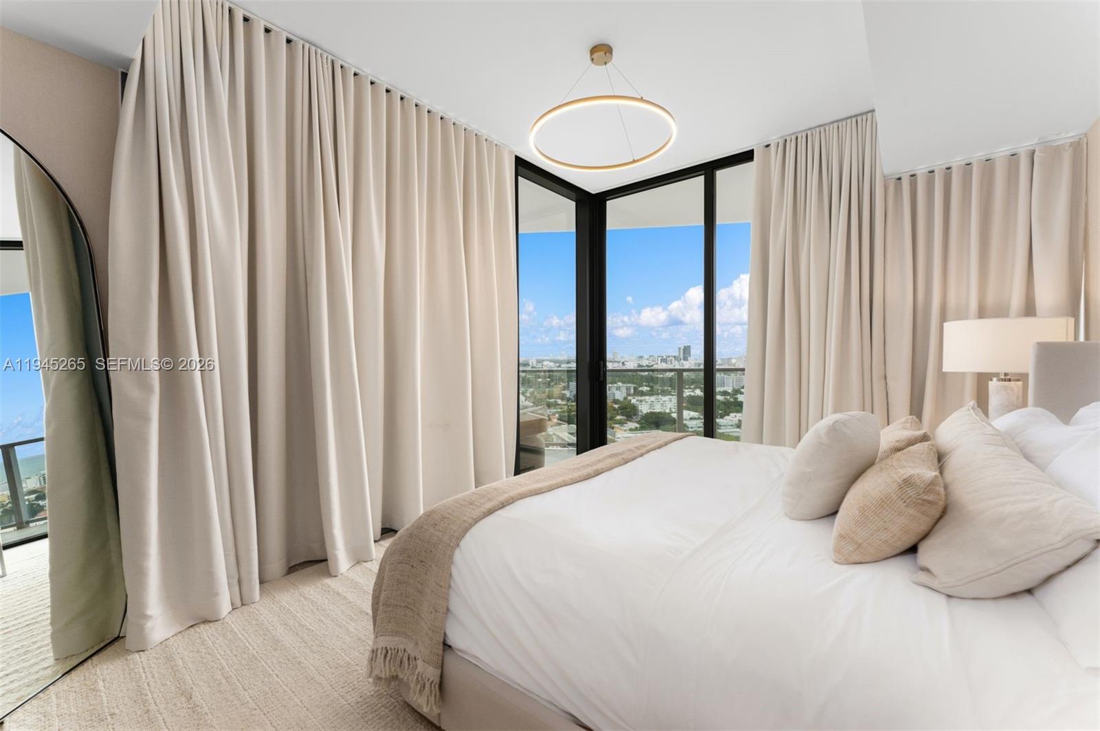 500 Alton Road, Unit 2105 Miami Beach, FL 33139 - Photo 20 of 44 a bedroom with a large bed and a large window