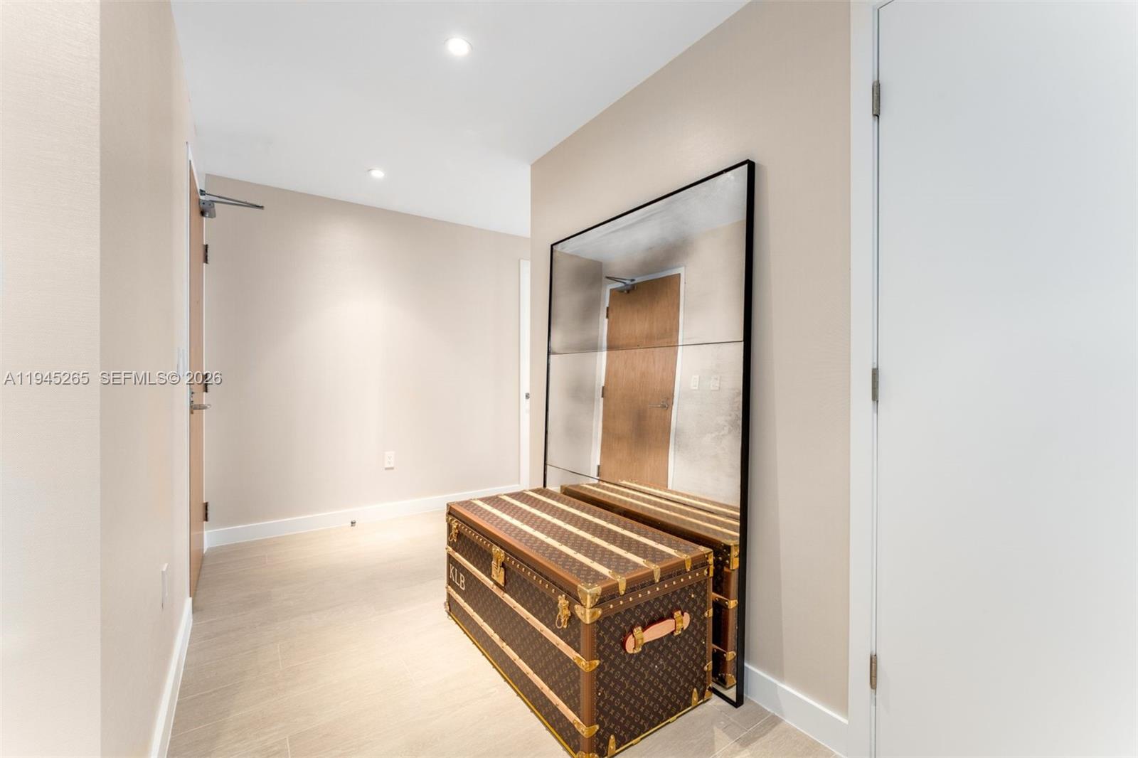 500 Alton Road, Unit 2105 Miami Beach, FL 33139 - Photo 24 of 44 a room with a bed and a mirror