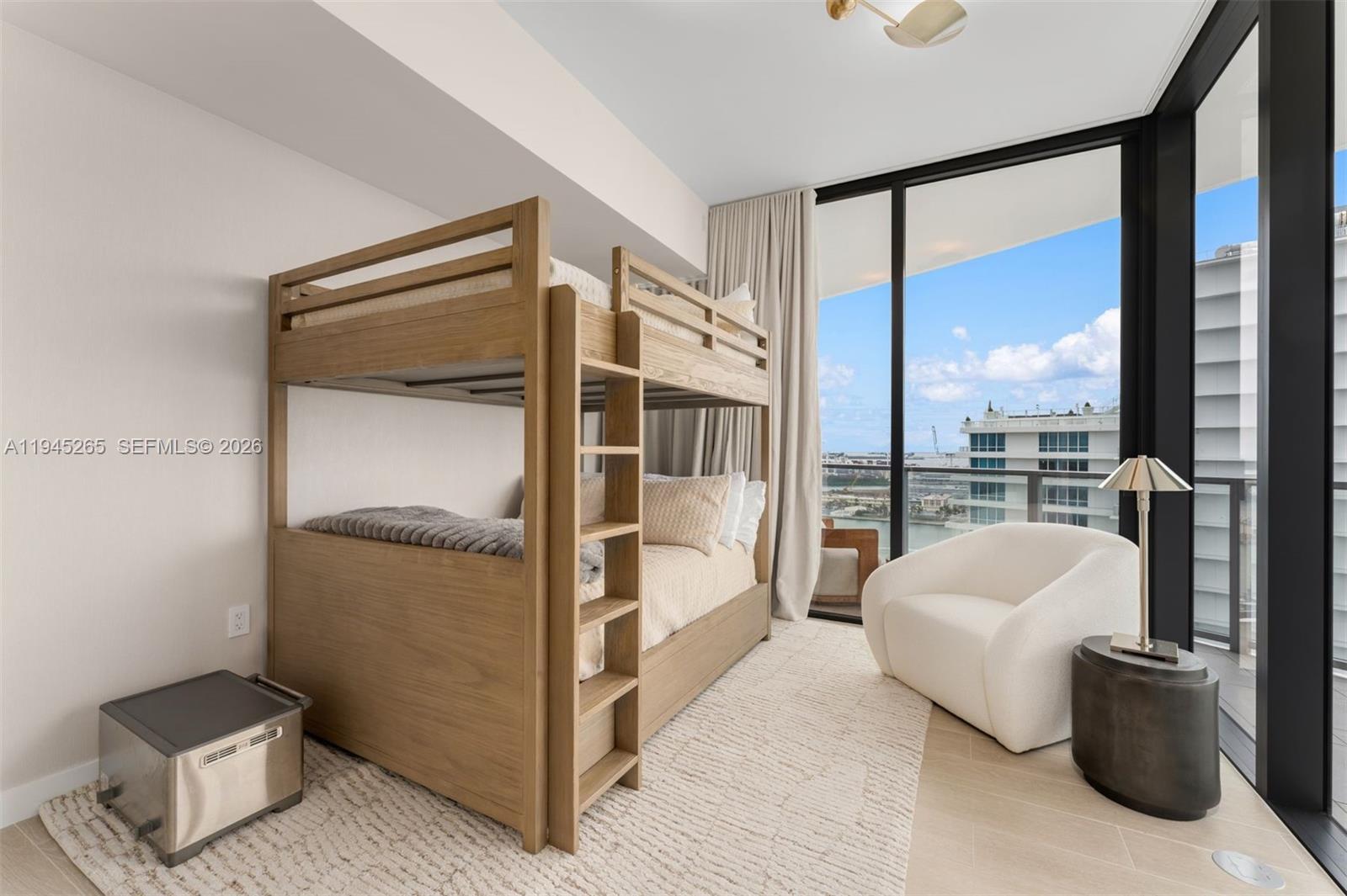 500 Alton Road, Unit 2105 Miami Beach, FL 33139 - Photo 25 of 44 a spacious bedroom with a balcony a bed and a potted plant