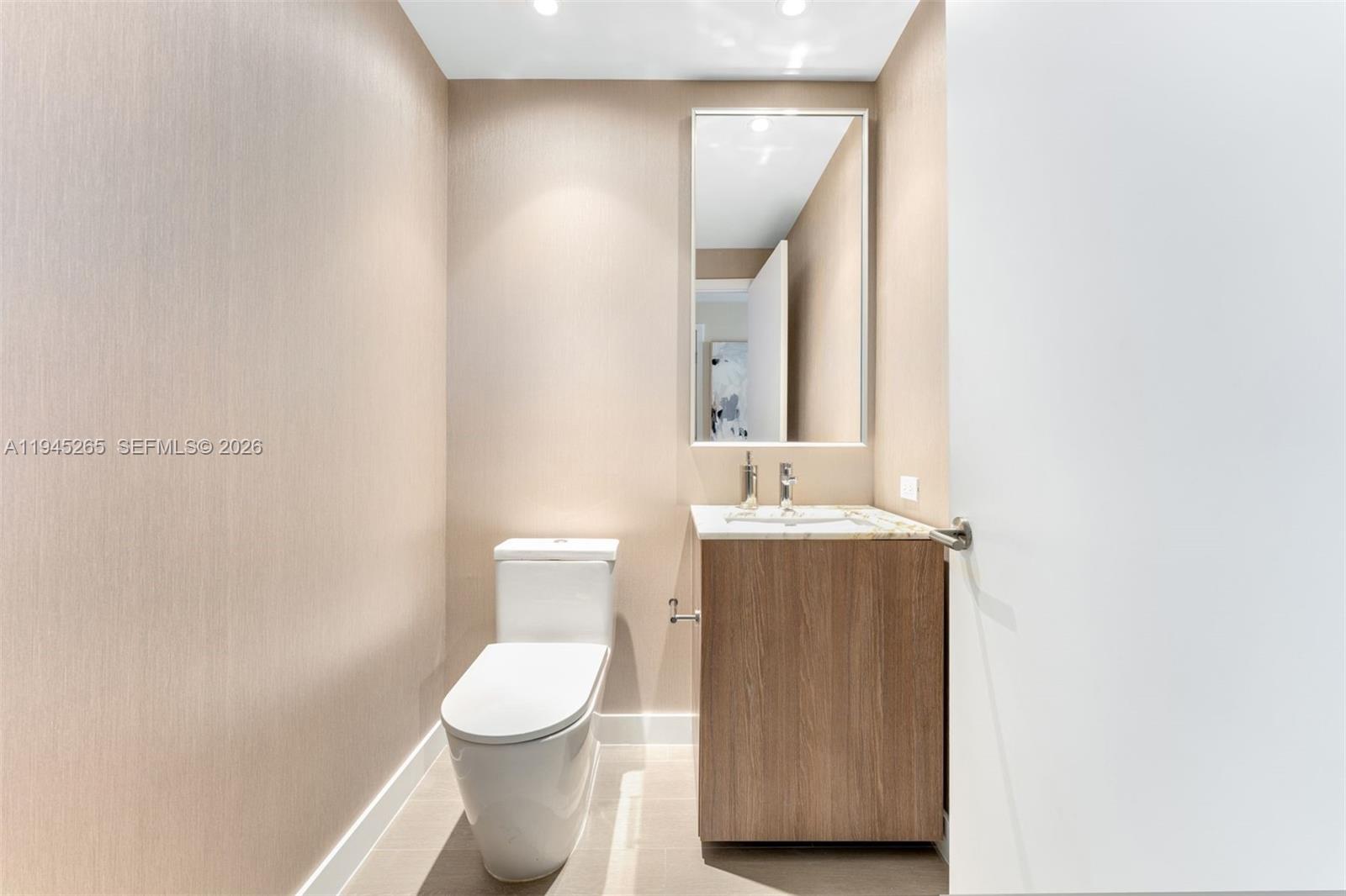 500 Alton Road, Unit 2105 Miami Beach, FL 33139 - Photo 26 of 44 a bathroom with a toilet sink and mirror