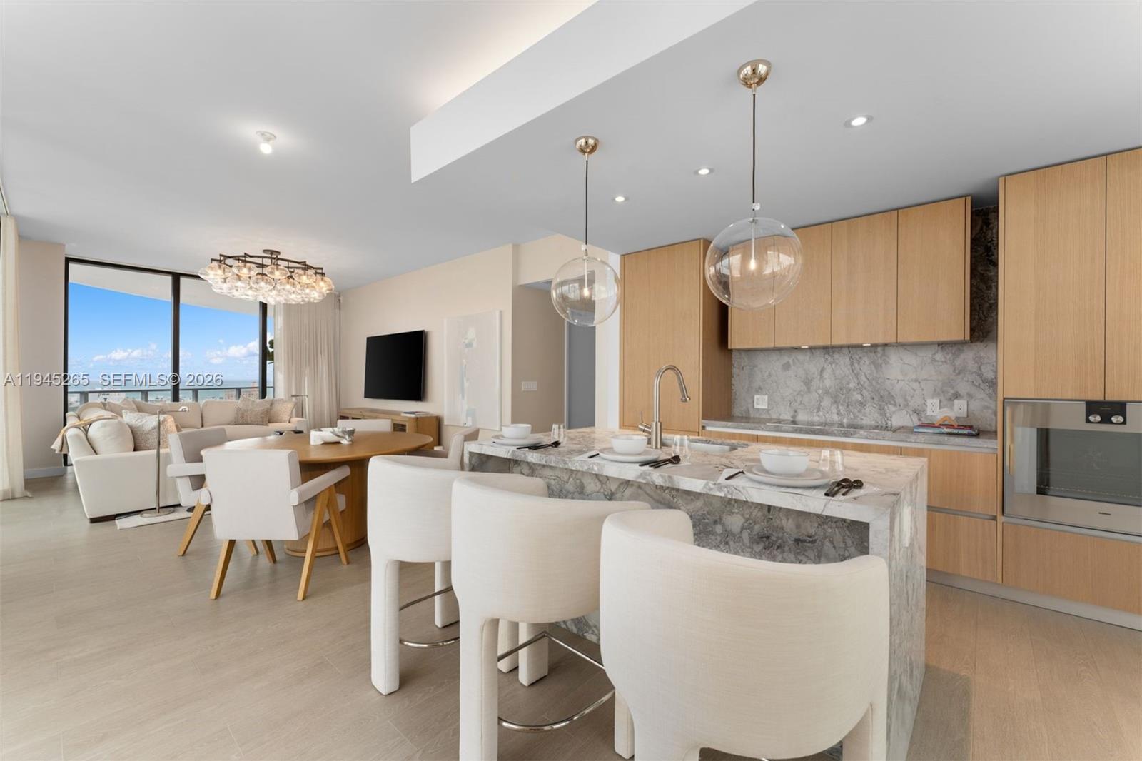 500 Alton Road, Unit 2105 Miami Beach, FL 33139 - Photo 6 of 44 a large kitchen with a table and chairs