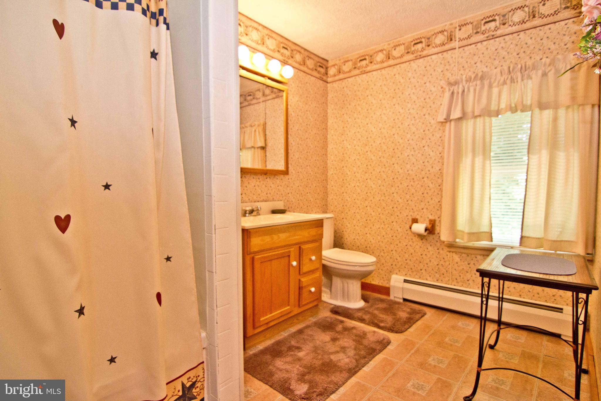 59 Market Street Salem, NJ 08079 - Photo 17 of 21 a spacious bathroom with a granite countertop sink a toilet and shower