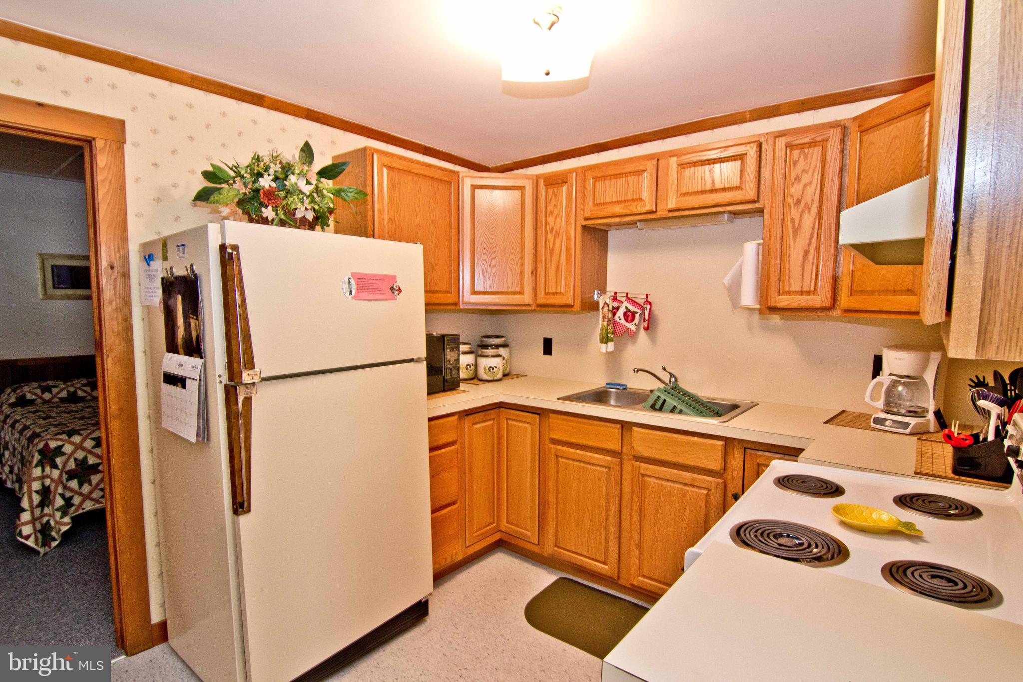 59 Market Street Salem, NJ 08079 - Photo 18 of 21 a kitchen with stainless steel appliances a refrigerator sink and cabinets